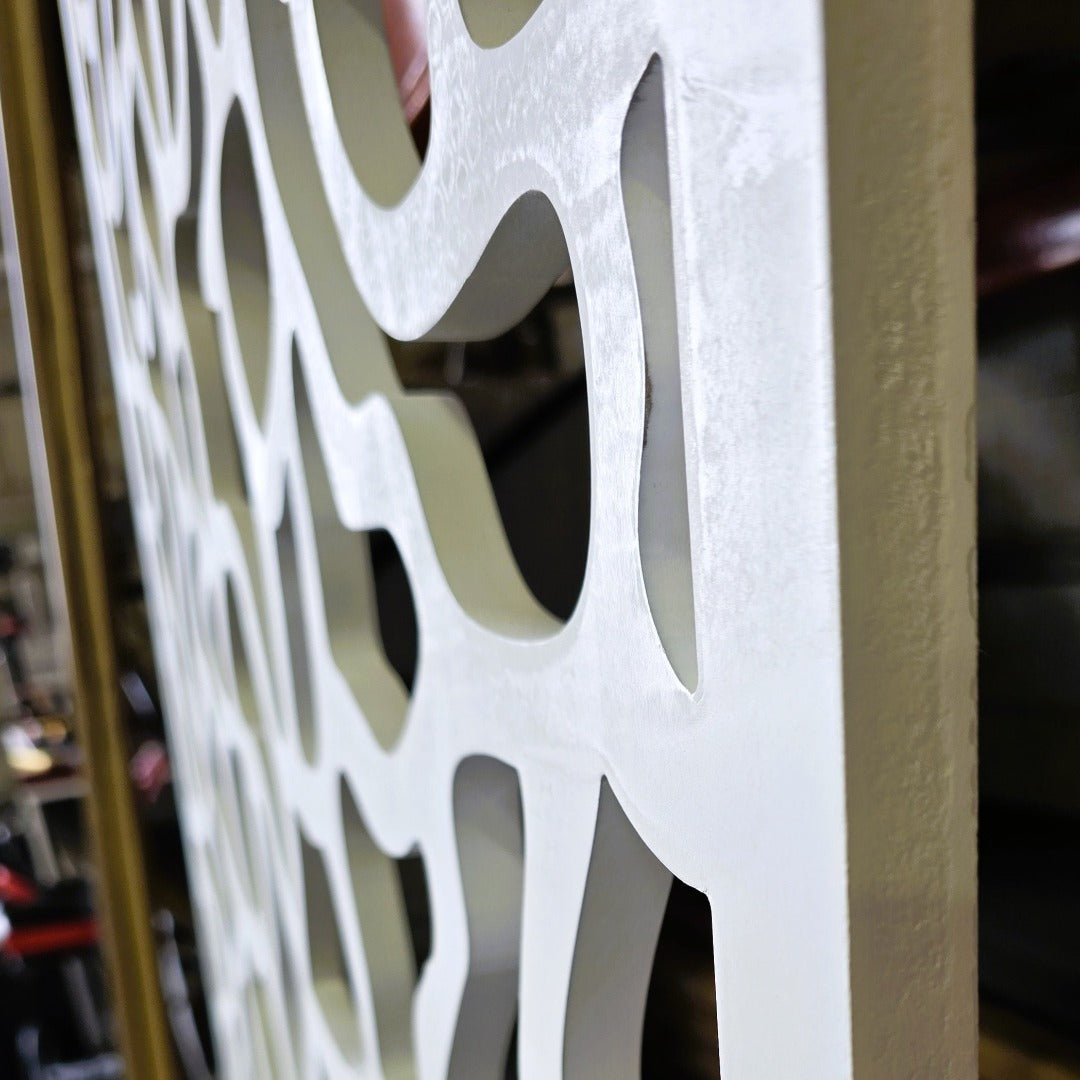 up close view showcasing the thickness  and intricate design of carved room divider panel