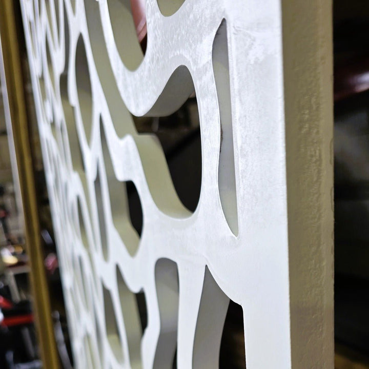 up close view showcasing the thickness  and intricate design of carved room divider panel