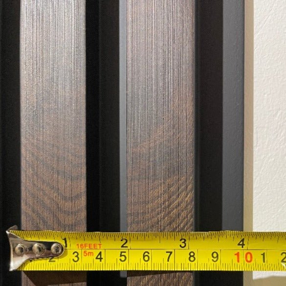 Measuring the dimensions of Dark Walnut Slat Wall Eco Panels with a tape measure