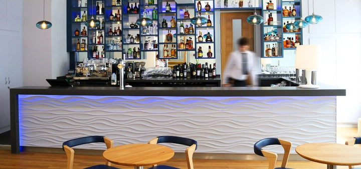 Jet Stream 3D MDF Wall Panel featured in a bar with ambient blue lighting