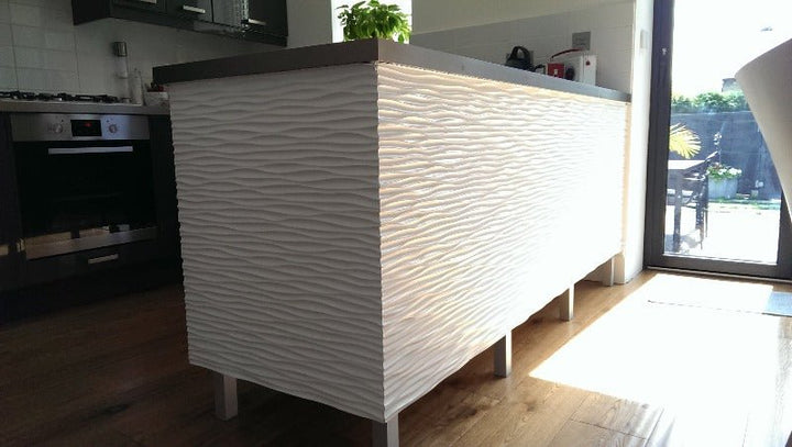 Kitchen showcasing a white 3D ocean wave MDF panel as a backsplash with wooden accents