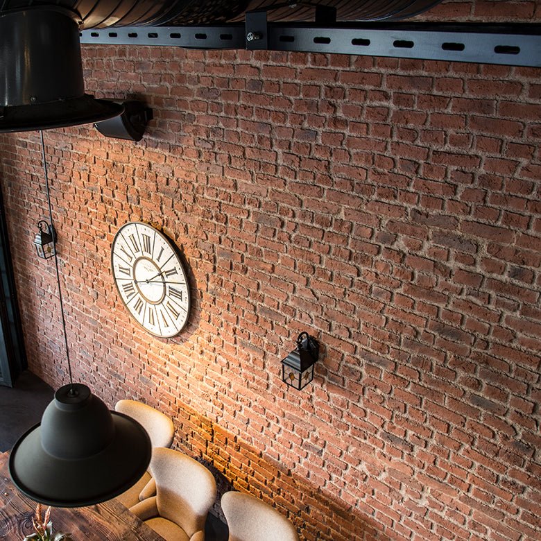 Tall View of an industrial styled dining space featuring london brick wall panels