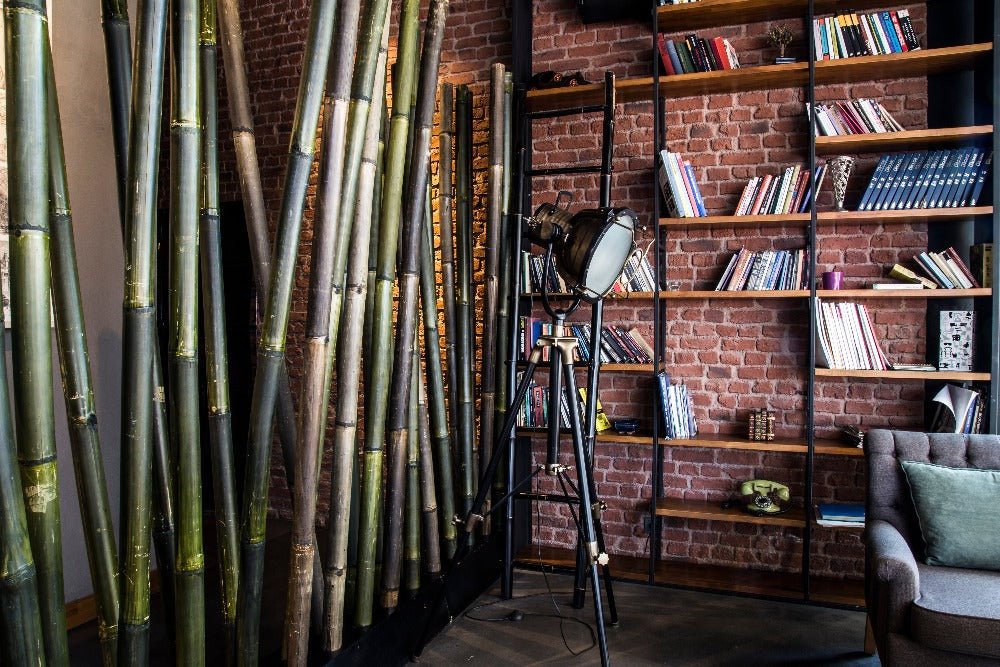 a contemporary and stylish living space with brick wall panels behind an open bookcase