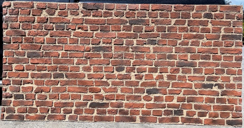 front facing view of rustic style brick wall panel outside in bright lighting