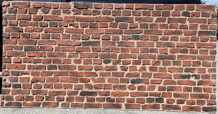 front facing view of rustic style brick wall panel outside in bright lighting