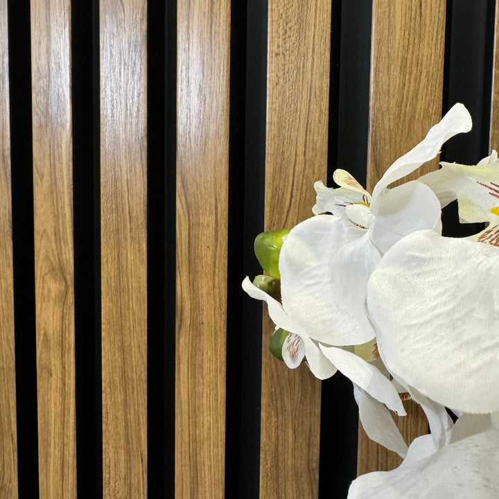 English Oak Slat Wall Eco Panels used as a backdrop for a vase of white flowers