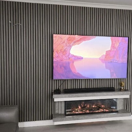 a flat screen tv mounted on a grey slat wall above a fireplace
