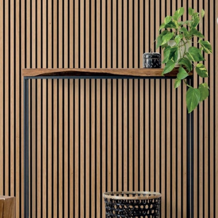 a potted plant sitting in front of a walnut slat wall