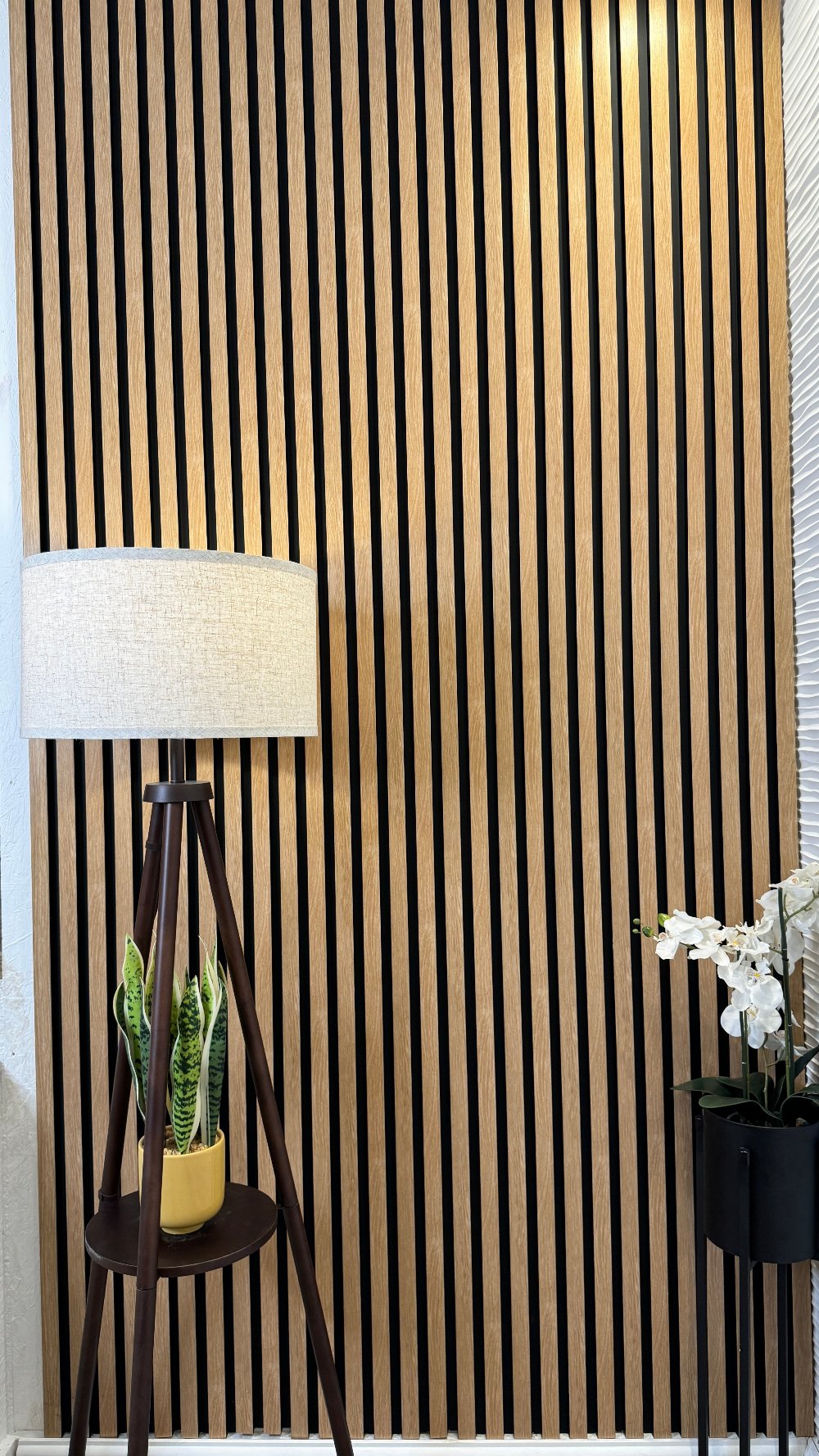 Interior setting showcasing American Beech Slat Wall Eco Panels with a black and light wood striped pattern