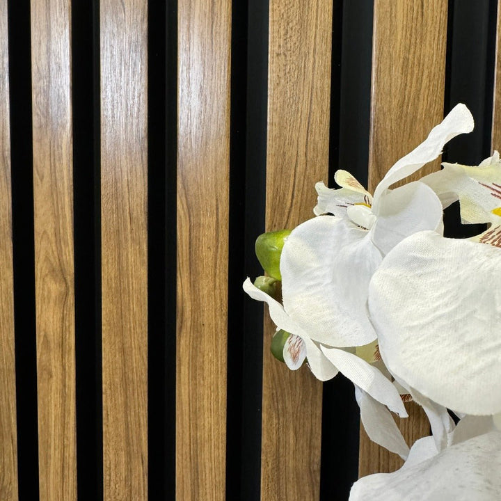 English Oak Slat Wall Eco Panels used as a backdrop for a vase of white flowers