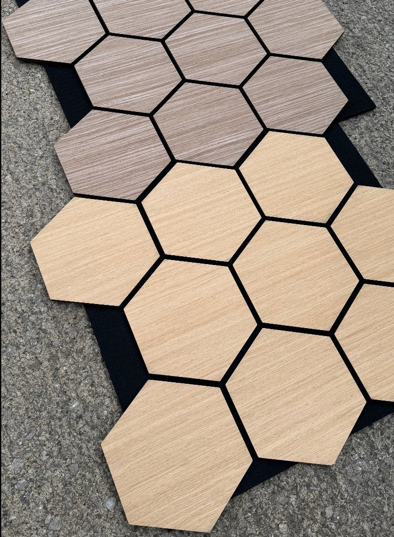 Array of Dark Walnut Hex Acoustic Tiles arranged on a flat surface to demonstrate install